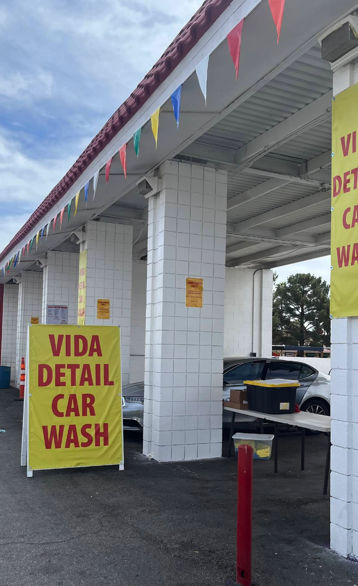 The Vida Detail Car Wash bay at 5853 W Tropicana Ave with bright yellow banners and pennants.